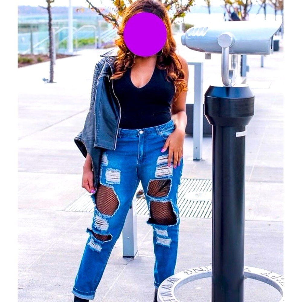 Blue ripped jeans with black mesh.